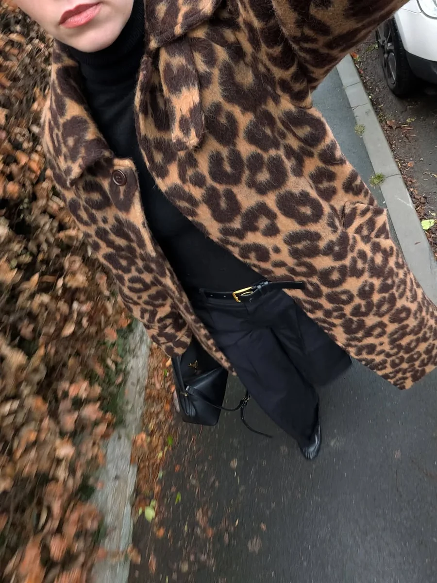 Leopard Coats Love an All-Black Base on a petite woman