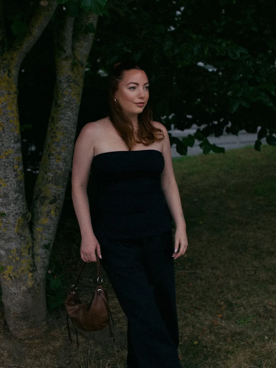 The Black Strapless Column on a petite woman