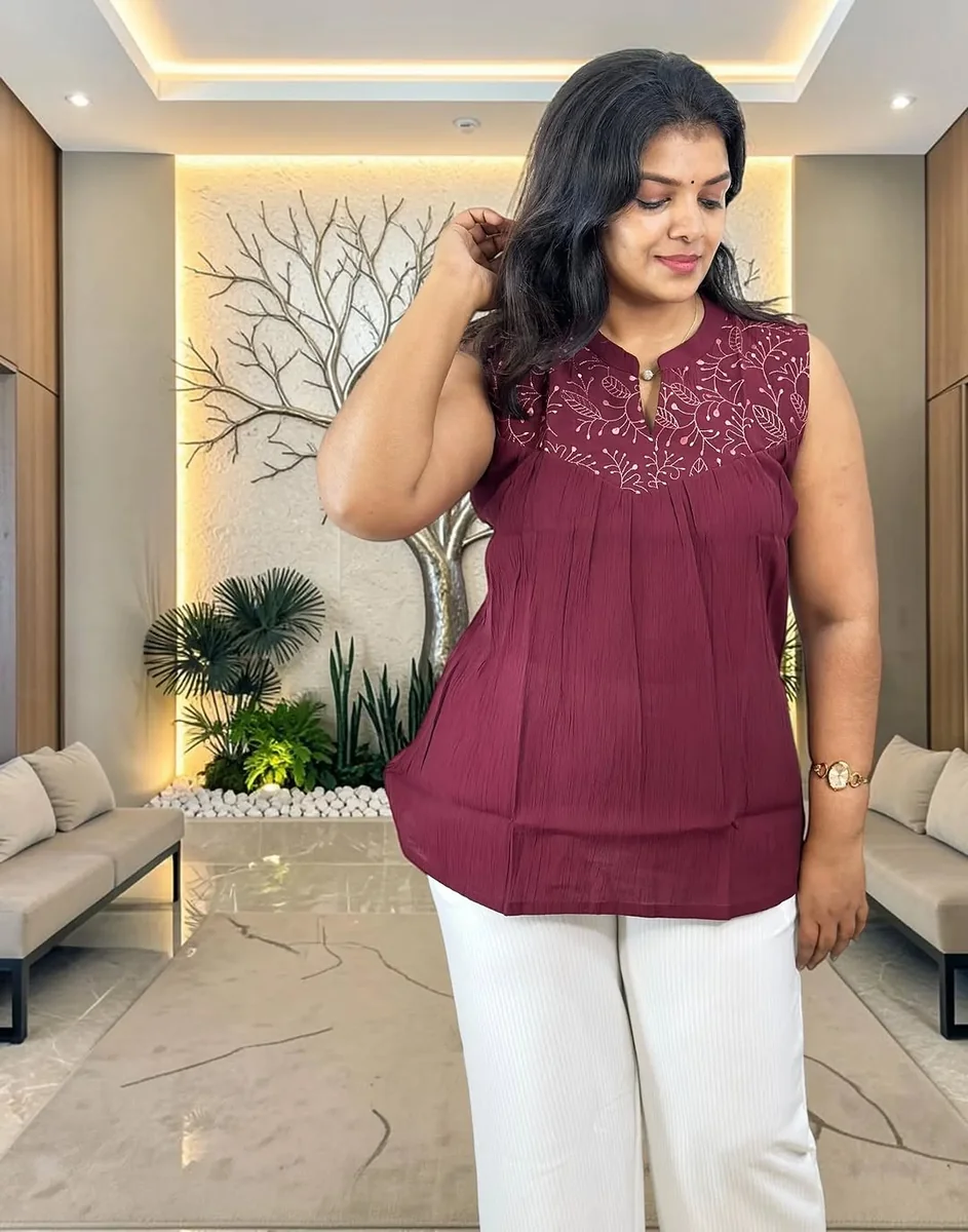 Embroidered Tunics and White Trousers on a petite woman