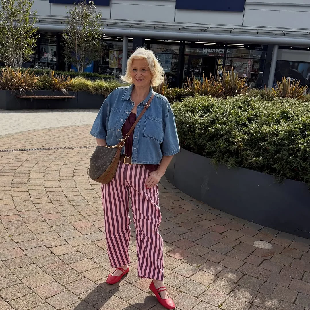 Pink Stripes, a Cropped Denim Shirt, and Red Mary Janes on a petite woman