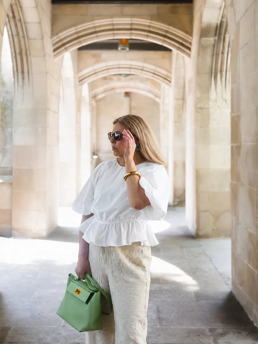 Head-to-Toe Cream With One Green Bag on a petite woman