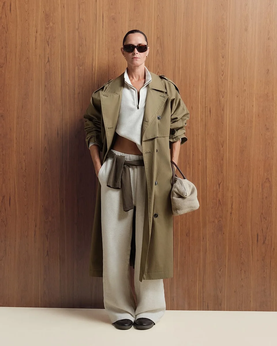 The Long Olive Trench Over Cream Wide Legs on a petite woman