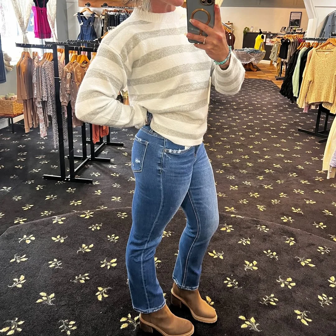 Striped Sweater, Straight Jeans, Tan Boots on a petite woman