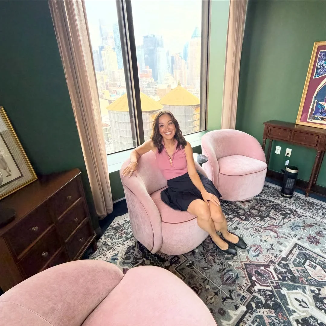 The Pink Sleeveless Top That Softens a Dark Navy Skirt on a petite woman