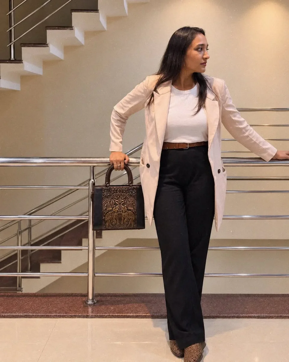 Blush Blazer, White Top, and Black Wide Trousers on a petite woman