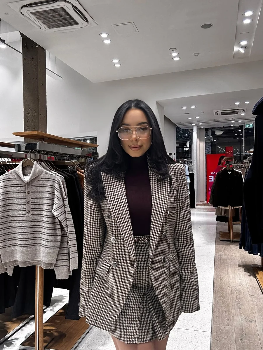 Houndstooth Blazer and Skirt With a Burgundy Turtleneck on a petite woman