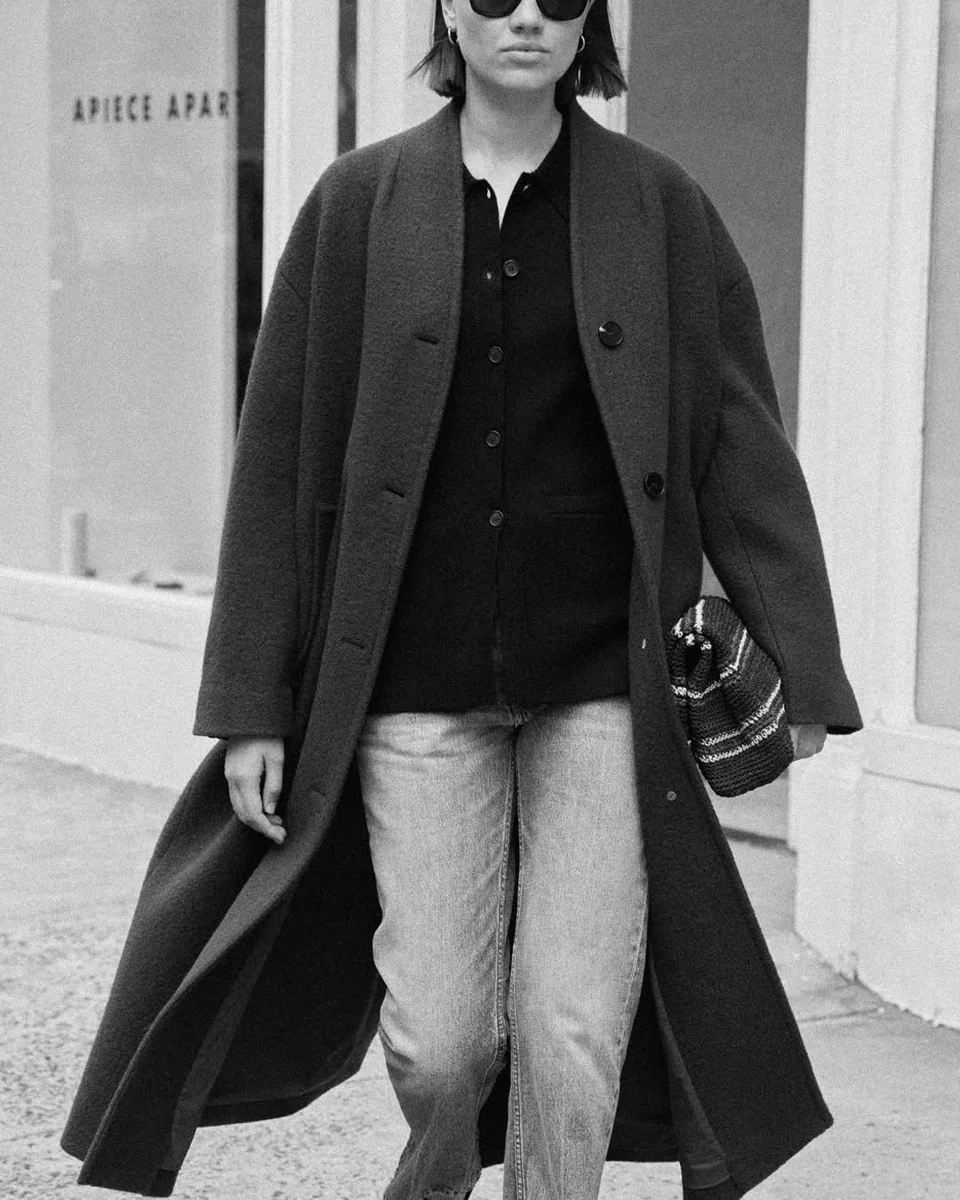 Long Dark Coat Over Jeans and a Cardigan on a petite woman