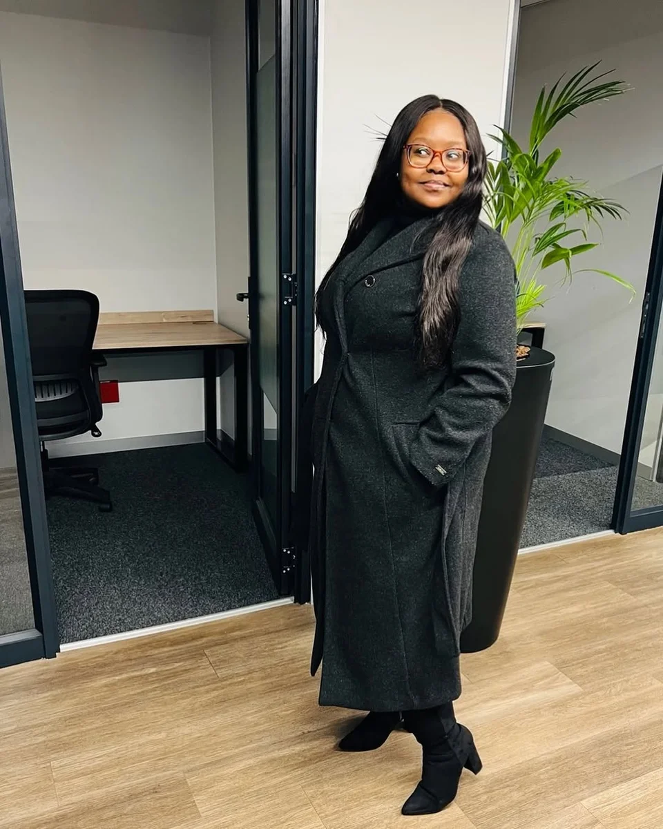 Charcoal Coat Over an All-Black Base on a petite woman