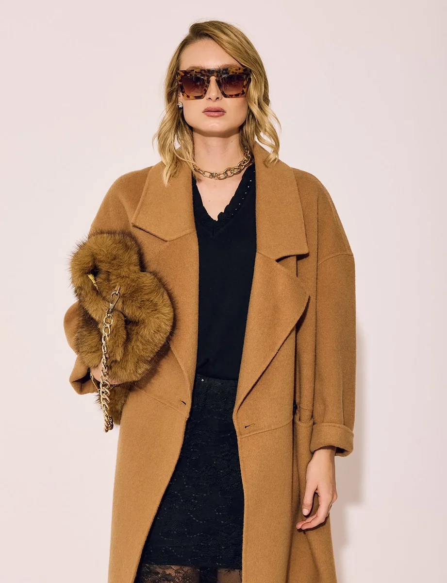 Camel Coat Over Black Layers on a petite woman