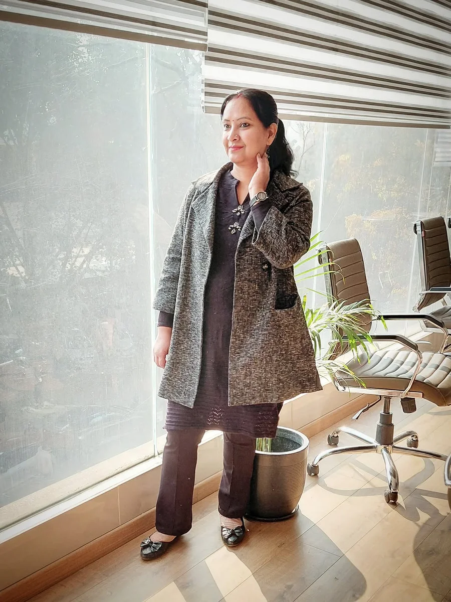 Embroidered Tunic and Trousers Under a Textured Coat on a petite woman