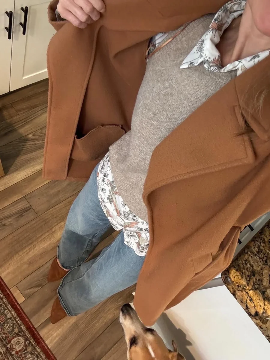 Sweater Vest Over a Floral Shirt, Camel Coat on Top on a petite woman