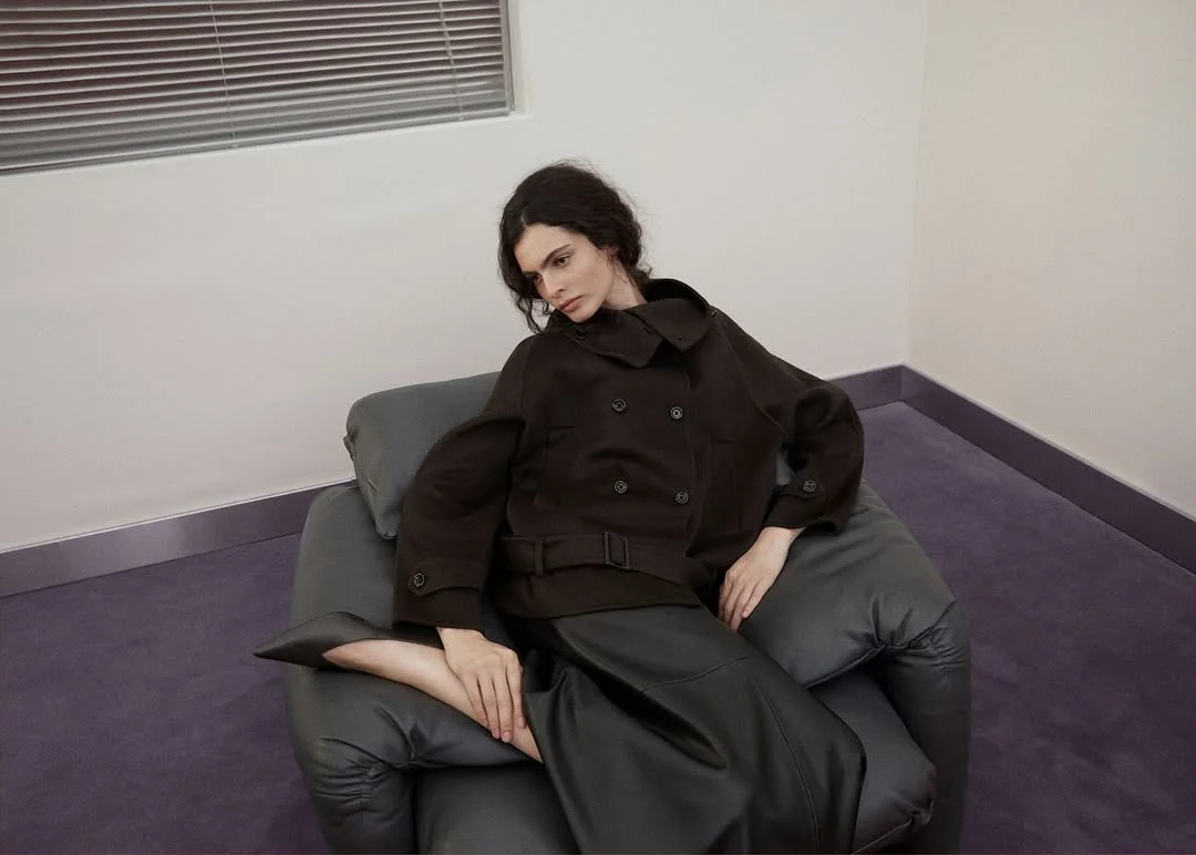 The Belted Short Coat Over a Leather Skirt on a petite woman