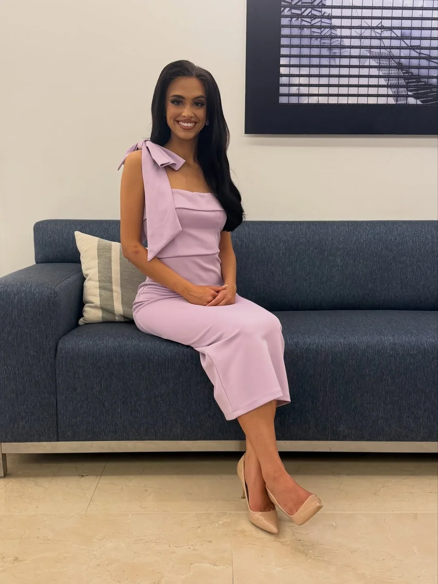 The Lavender Midi with a Bow-Shoulder Detail on a petite woman