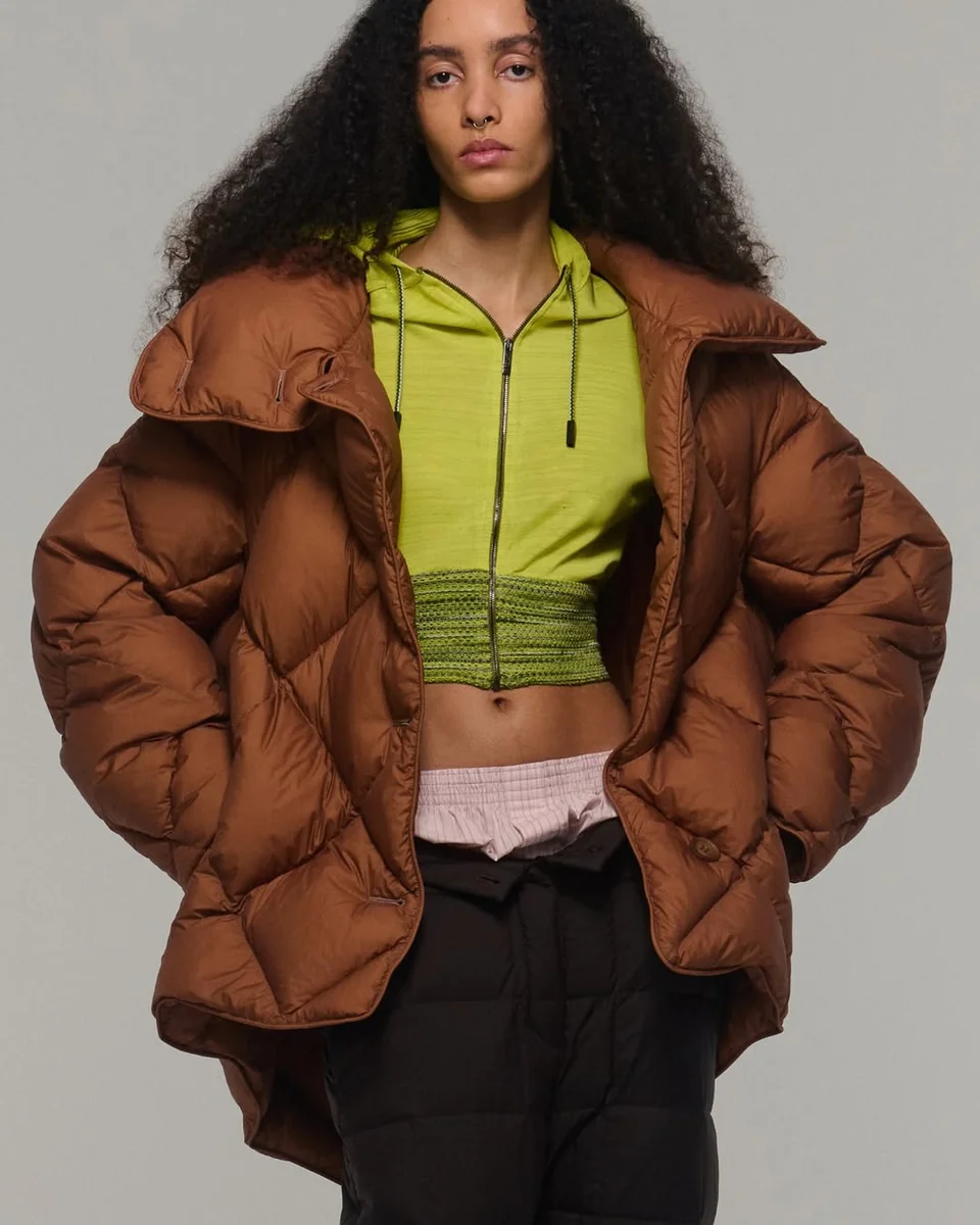 An Oversized Chocolate Puffer With a Lime Layer on a petite woman