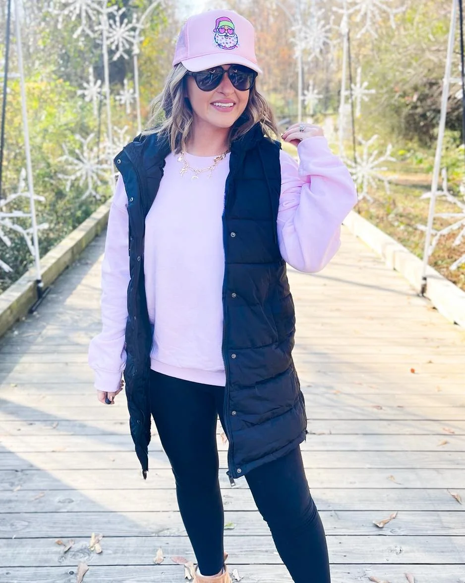 The Long Black Vest Over Pink and Leggings on a petite woman