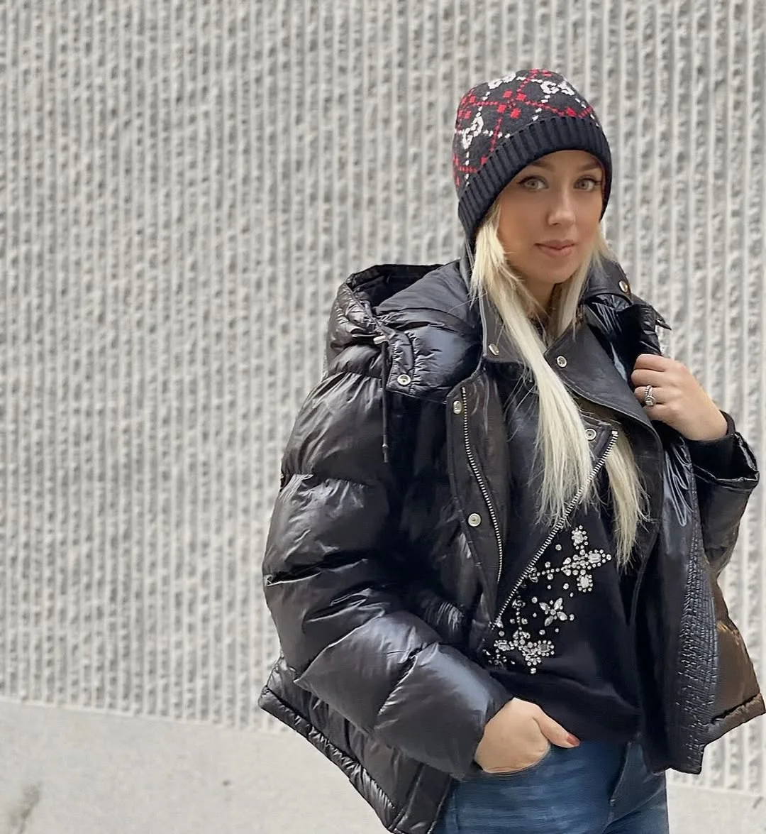 A Glossy Black Puffer, Dressed Up With a Beanie on a petite woman
