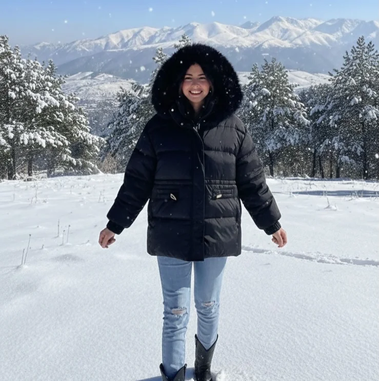 A Black Puffer, Ripped Jeans, and Snow Boots on a petite woman