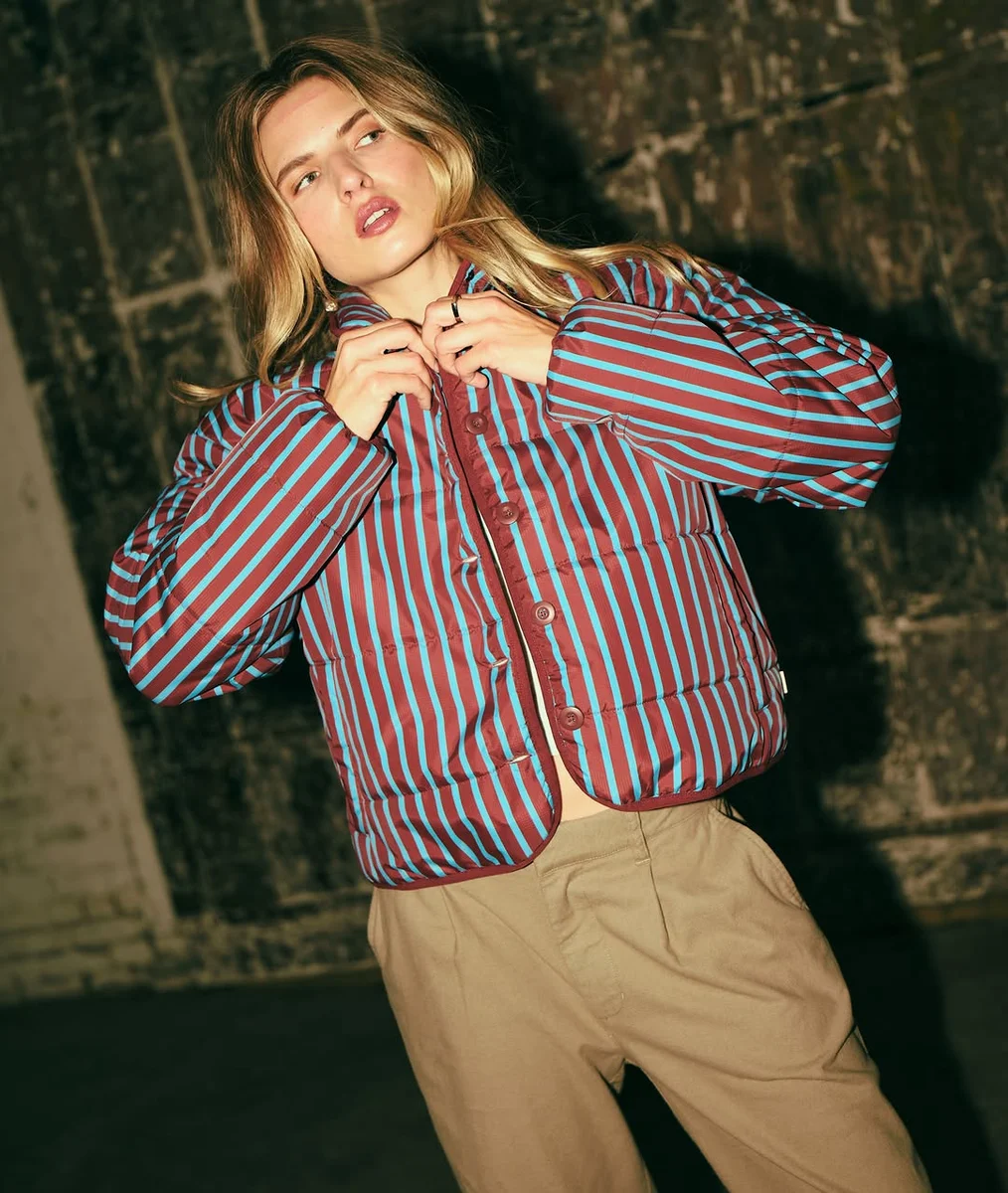 The Striped Cropped Puffer on a petite woman