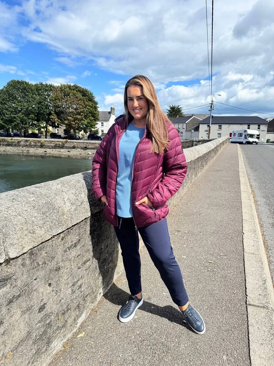 The Lightweight Berry Puffer for Milder Days on a petite woman