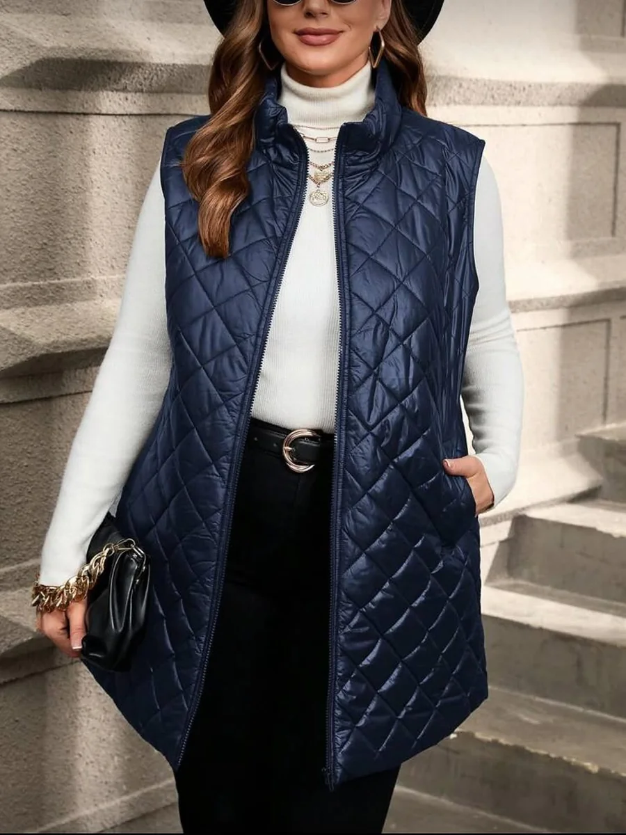 The Long Quilted Vest Over a White Turtleneck on a petite woman