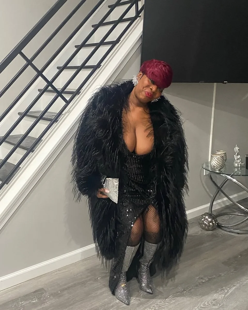 Black Sequin Mini, Feather Coat, Silver Boots on a petite woman