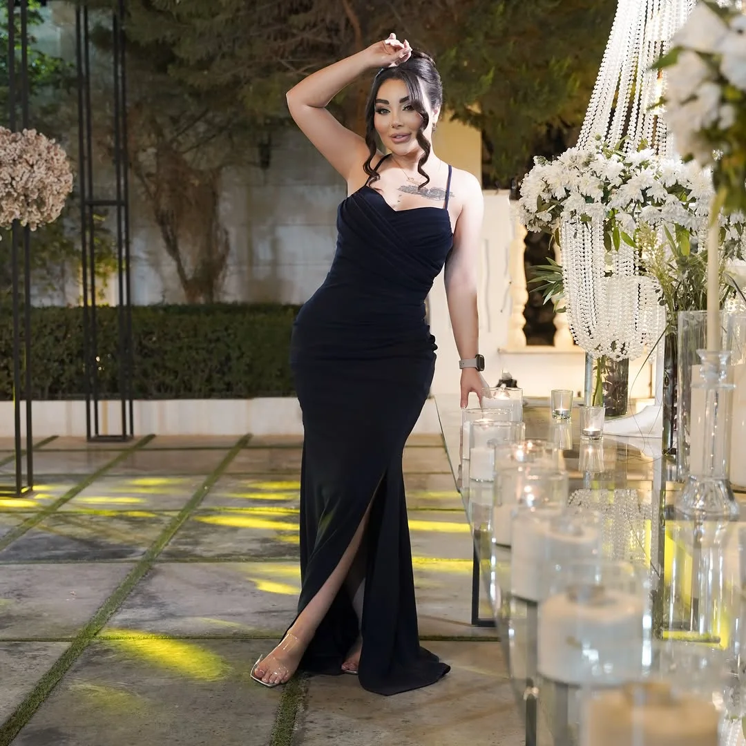 Black Strapless Mermaid Gown With a Slit on a petite woman