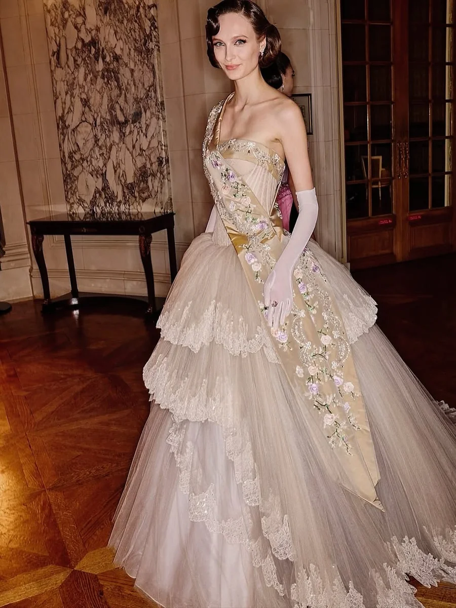 Ivory Tiered Ball Gown With Gloves on a petite woman